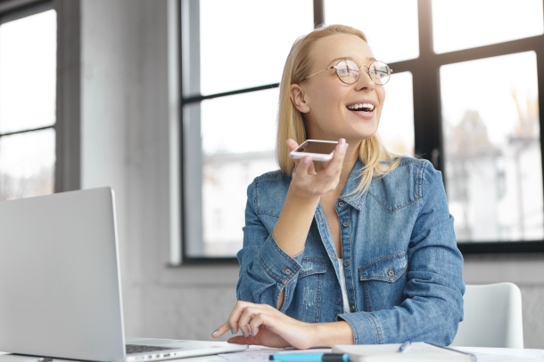 Woman using speech recognition for dictation